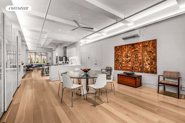 dining space featuring a wall mounted AC, light wood-type flooring, and ceiling fan
