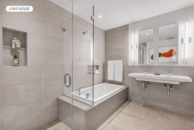 bathroom with tile walls, a stall shower, a garden tub, tile patterned flooring, and recessed lighting