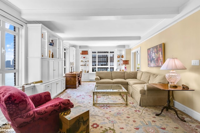 living area featuring beam ceiling and crown molding