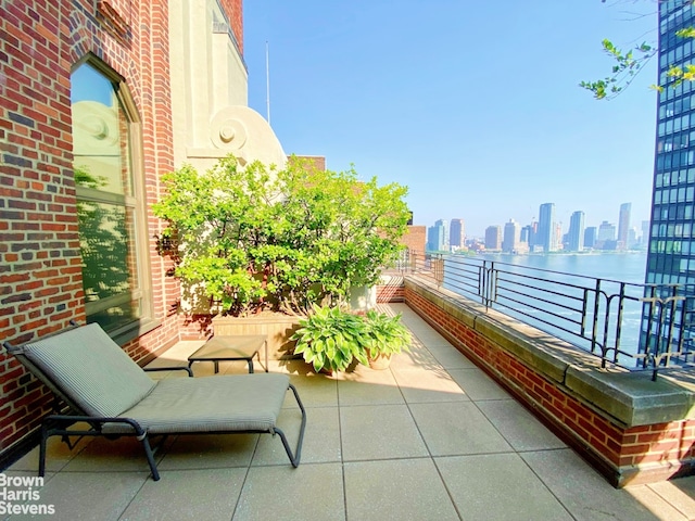 balcony featuring a view of skyline and a water view