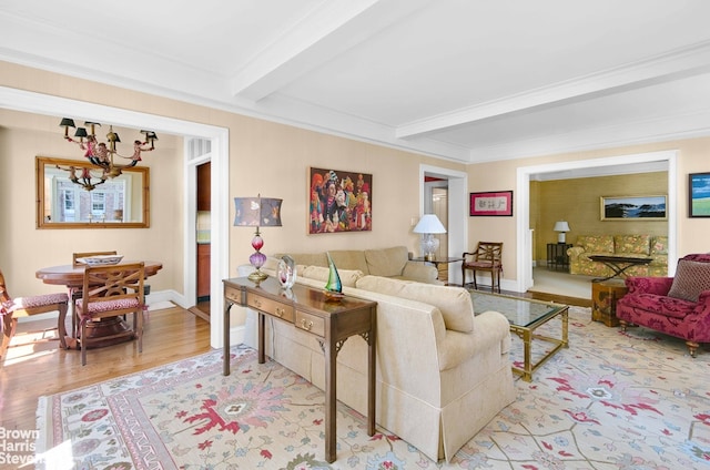living area featuring a chandelier, beam ceiling, light wood-style floors, and baseboards