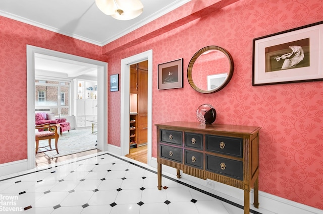 hall featuring ornamental molding, baseboards, tile patterned floors, and inlaid floor details