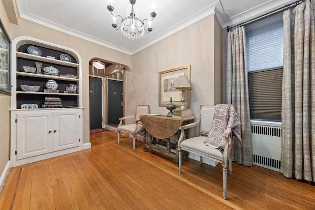 125 W 96th St Unit 1A, New York City, NY 10025 - sitting room with ornamental molding, light wood-style flooring, a chandelier, arched walkways, and radiator