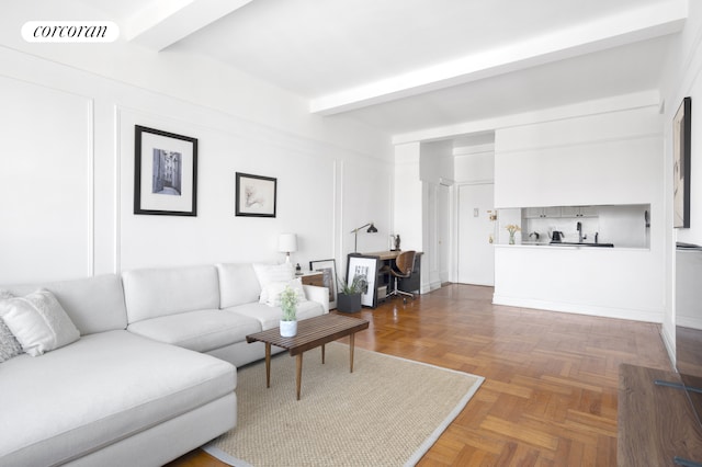 living area with beamed ceiling and an office area