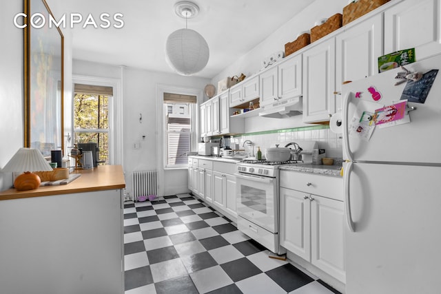 139 N 8th St, New York City, NY 11249 - kitchen featuring white appliances, radiator, dark flooring, under cabinet range hood, and light countertops