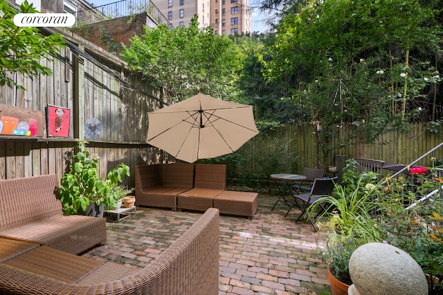 view of patio with an outdoor living space and a fenced backyard