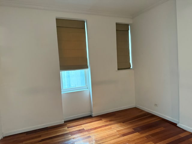 57 W 58th St Unit 3H, New York City, NY 10019 - unfurnished room featuring ornamental molding, wood finished floors, and baseboards