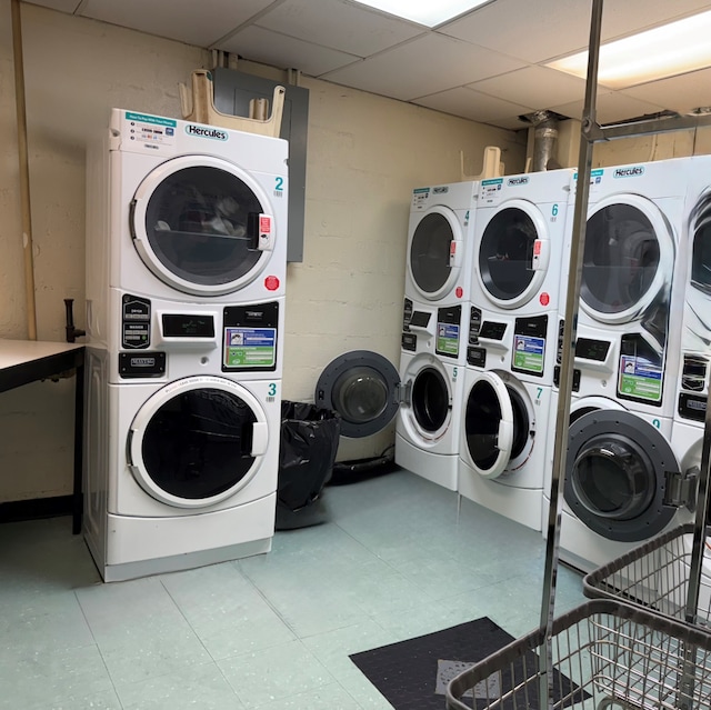57 W 58th St Unit 3H, New York City, NY 10019 - shared laundry room with stacked washer / drying machine, light floors, and washer and clothes dryer