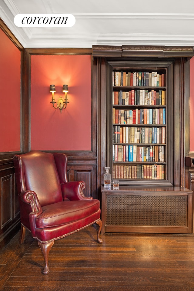 sitting room featuring radiator heating unit, ornamental molding, and wood finished floors