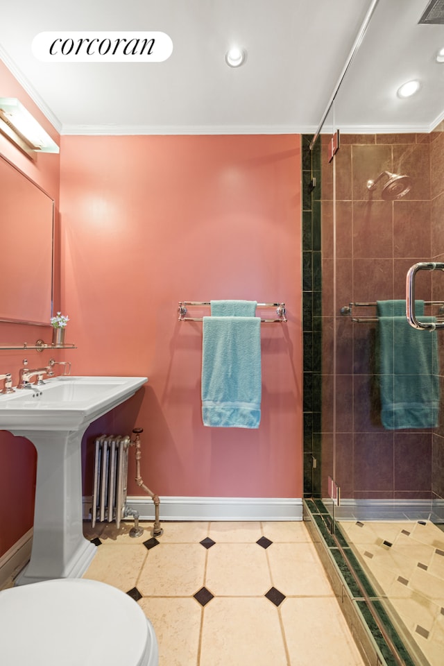 full bath with crown molding, a stall shower, toilet, radiator heating unit, and baseboards