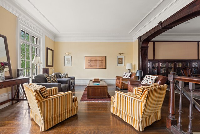 living area featuring wood finished floors and crown molding