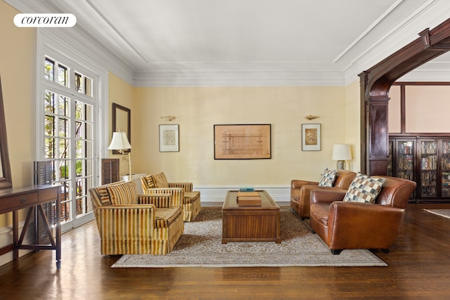 living area with wood finished floors and crown molding