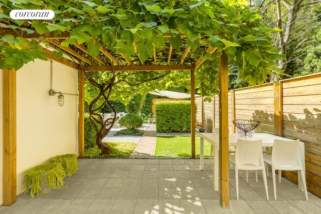 view of patio with fence and outdoor dining space