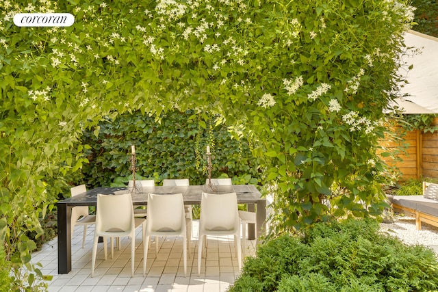 view of patio / terrace featuring outdoor dining area and fence