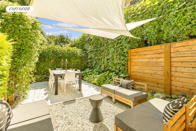 view of patio with fence and outdoor dining area