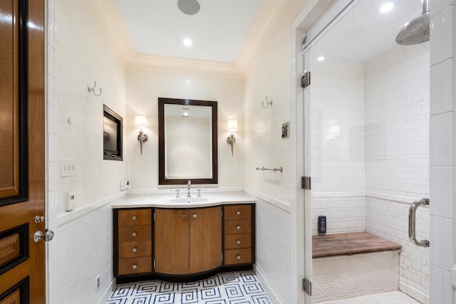 415 E 54th St Unit 25Gg, New York City, NY 10022 - bathroom with a stall shower, vanity, ornamental molding, tile walls, and wainscoting