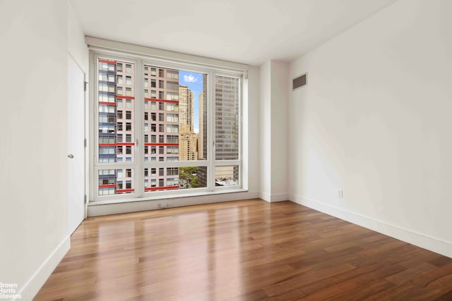 250 E 53rd St Unit 1502, New York City, NY 10022 - spare room featuring wood finished floors and plenty of natural light