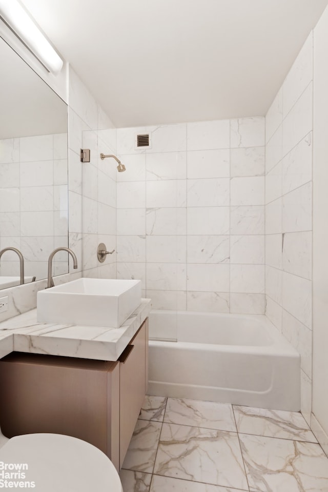 250 E 53rd St Unit 1502, New York City, NY 10022 - full bath with marble finish floors, vanity, washtub / shower combination, and tile walls