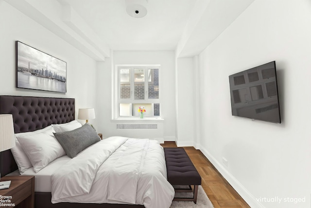 bedroom with radiator heating unit and baseboards