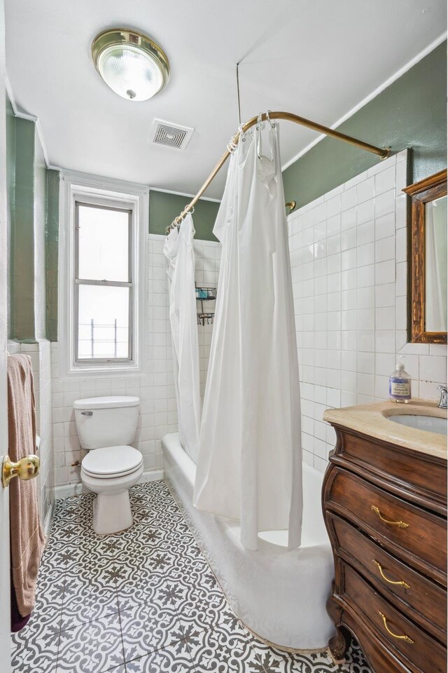 1075 Grand Concourse Unit 4G, New York City, NY 10452 - full bathroom featuring tile walls, shower / tub combo with curtain, toilet, tile patterned flooring, and vanity