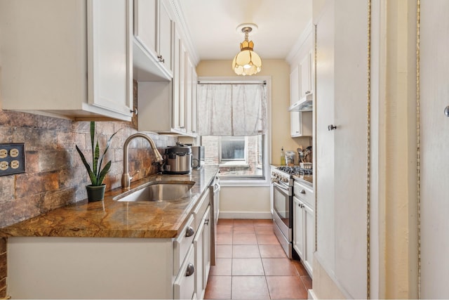 1075 Grand Concourse Unit 4G, New York City, NY 10452 - kitchen with stainless steel appliances, a sink, white cabinetry, and backsplash