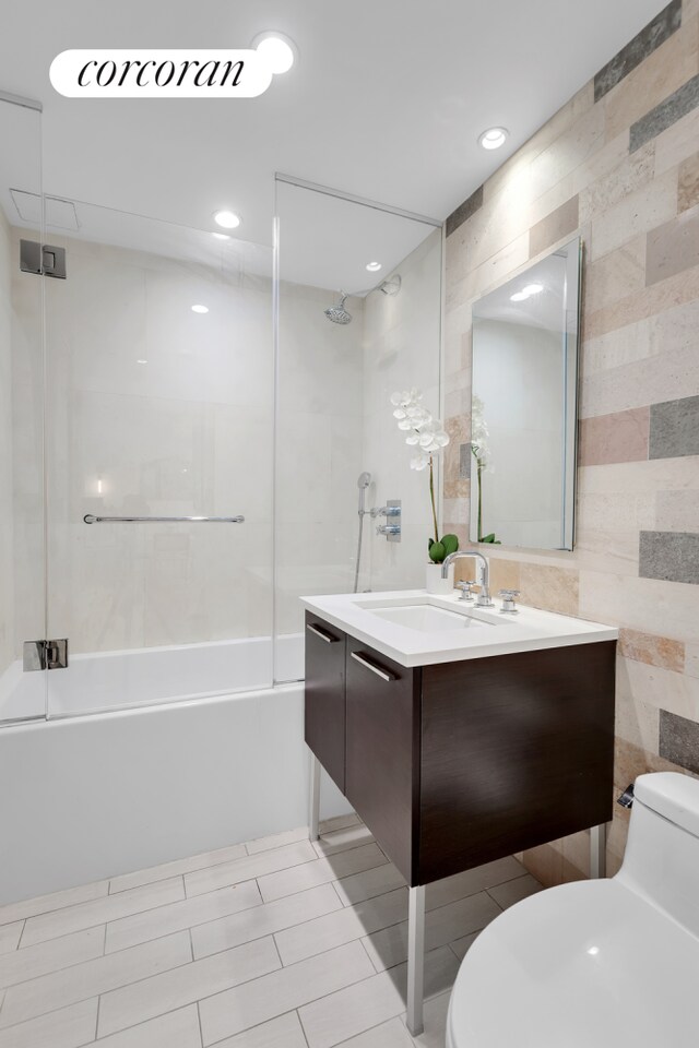 bathroom with toilet, vanity,  shower combination, recessed lighting, and tile patterned floors