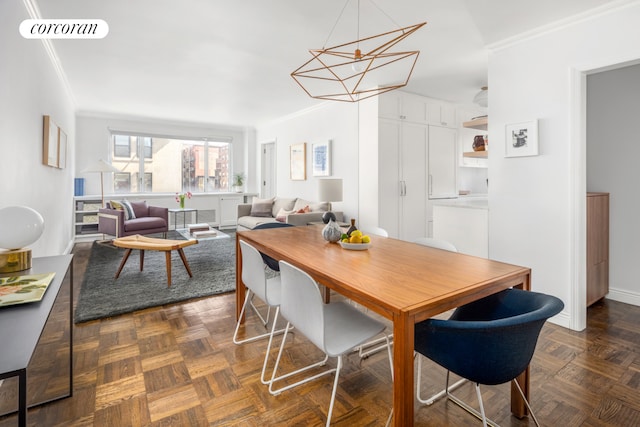 105 W 13th St Unit 4C, New York City, NY 10011 - dining room featuring crown molding, a chandelier, and baseboards