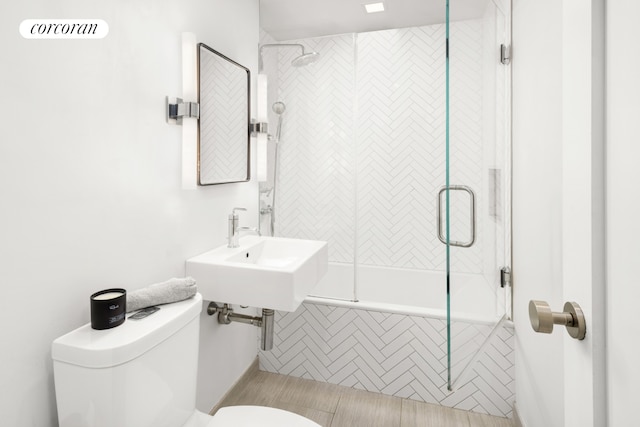 bathroom with toilet, a sink, tiled shower / bath, and tile patterned flooring