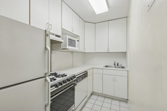 kitchen featuring white appliances, a sink, white cabinetry, and light countertops