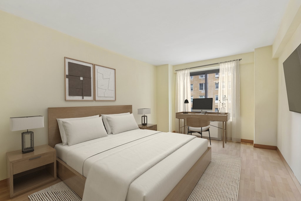 bedroom featuring light wood-style flooring and baseboards