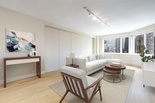 411 E 53rd St Unit 19D, New York City, NY 10022 - living area featuring rail lighting and light wood-style flooring