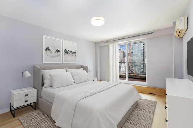 411 E 53rd St Unit 19D, New York City, NY 10022 - bedroom featuring a wall unit AC and light wood-style floors