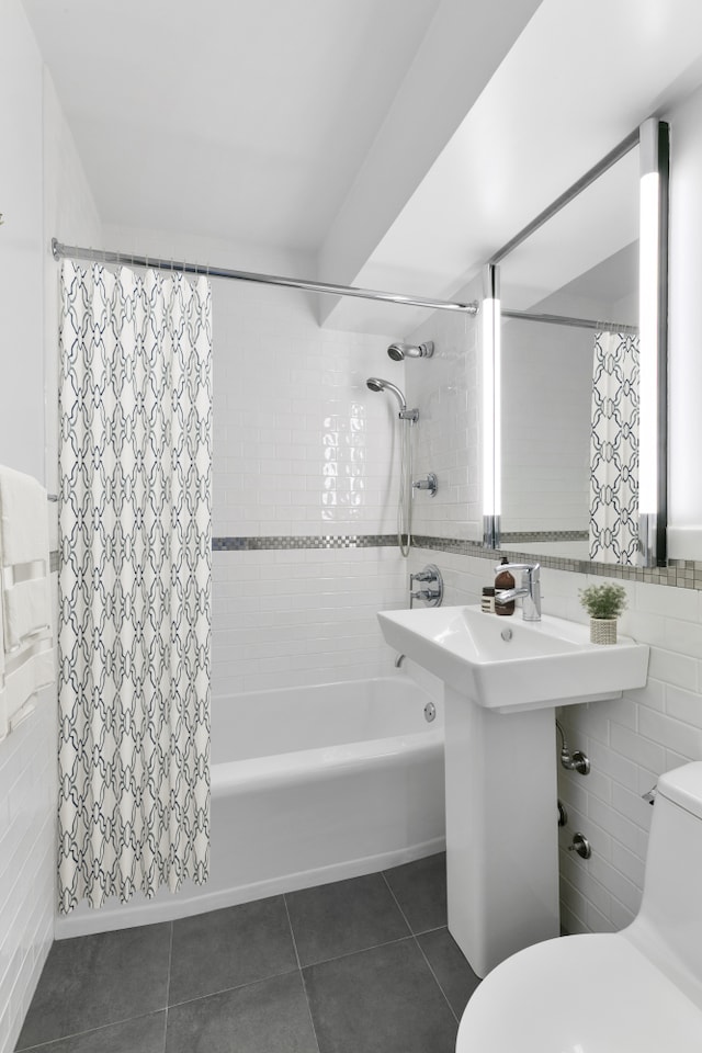 411 E 53rd St Unit 19D, New York City, NY 10022 - full bathroom featuring tile walls, toilet, tile patterned floors, and shower / bathtub combination with curtain