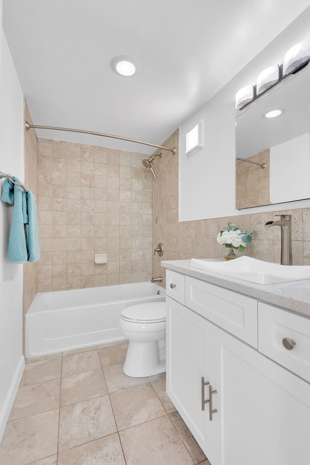 full bathroom featuring tile walls, shower / washtub combination, toilet, and vanity