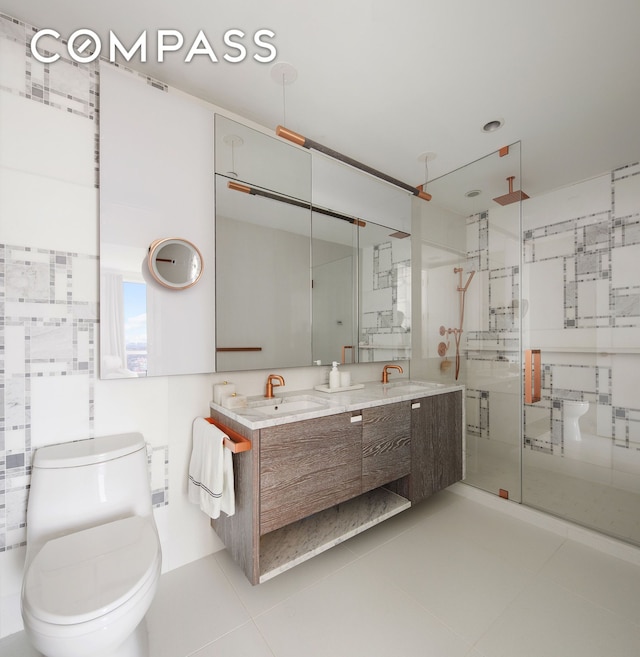 bathroom with a shower stall, toilet, tile patterned floors, and double vanity
