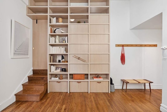 interior space with wood finished floors and baseboards