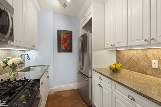 250 W 89th St Unit 8H, New York City, NY 10024 - kitchen featuring appliances with stainless steel finishes, tasteful backsplash, white cabinets, and stone counters