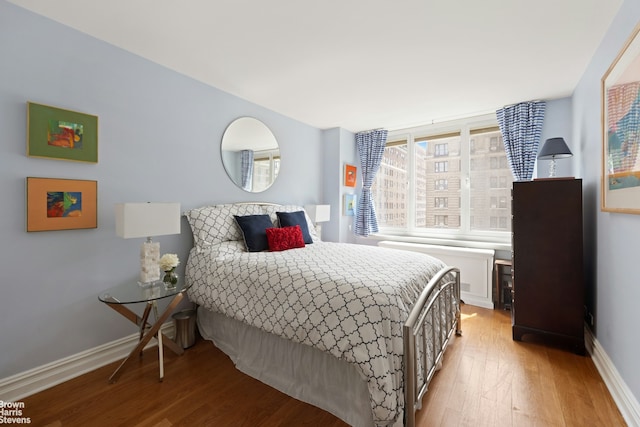 bedroom featuring light wood-style floors and baseboards
