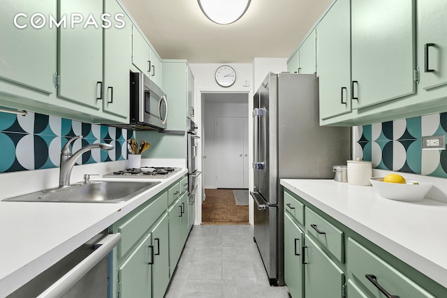 1199 Park Ave Unit 2F, New York City, NY 10128 - kitchen featuring green cabinets, appliances with stainless steel finishes, a sink, decorative backsplash, and light countertops