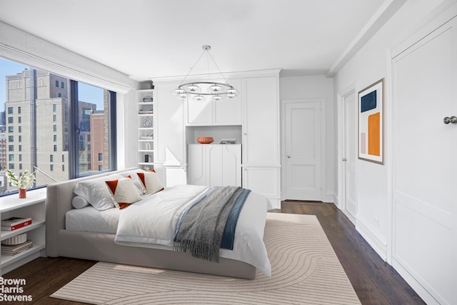 bedroom featuring a chandelier, dark wood-style flooring, and a city view