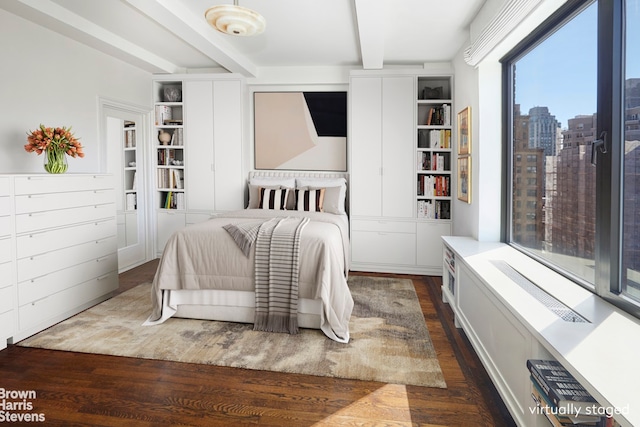 bedroom with beam ceiling and dark wood-type flooring