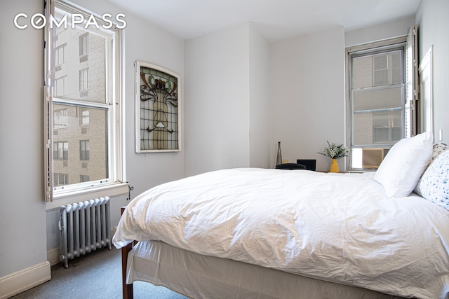 907 5th Ave Unit 4F, New York City, NY 10021 - carpeted bedroom featuring radiator and baseboards