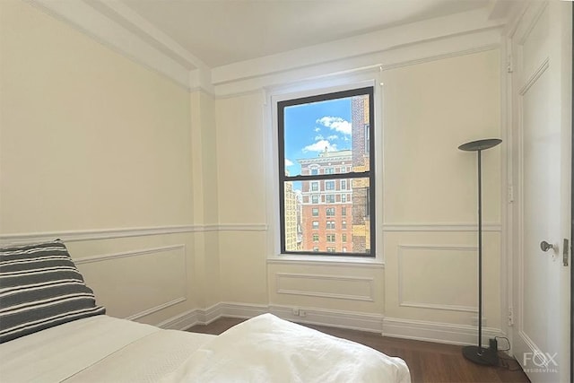 255 W End Ave Unit 12C, New York City, NY 10023 - bedroom with dark wood-style floors and a decorative wall