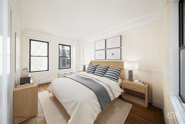 255 W End Ave Unit 12C, New York City, NY 10023 - bedroom featuring a decorative wall, wood finished floors, and a wainscoted wall