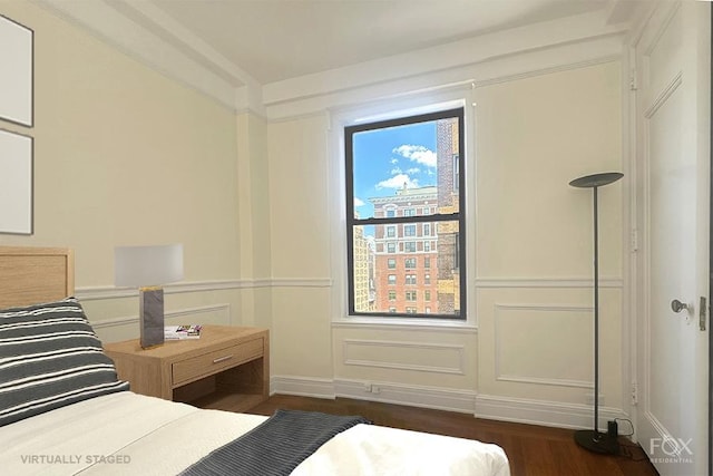 255 W End Ave Unit 12C, New York City, NY 10023 - bedroom featuring wood finished floors, a decorative wall, and a wainscoted wall