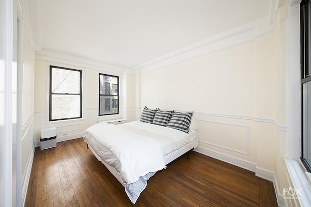 255 W End Ave Unit 12C, New York City, NY 10023 - bedroom with a decorative wall, dark wood-style flooring, and a wainscoted wall