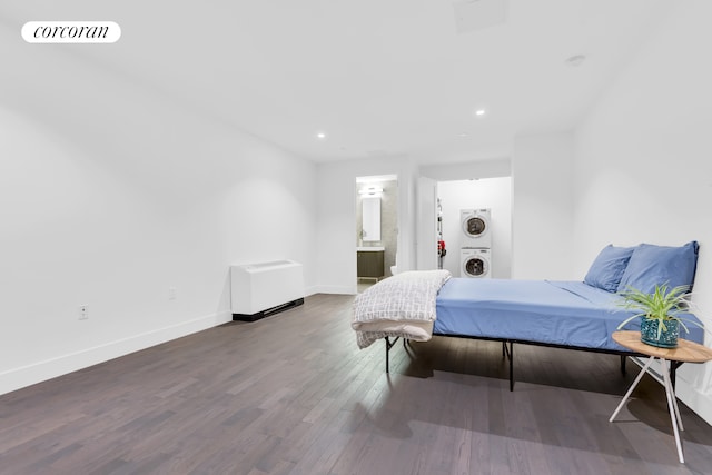 416 W 52nd St Unit Th215, New York City, NY 10019 - bedroom featuring estacked washer and dryer, wood finished floors, recessed lighting, and ensuite bathroom