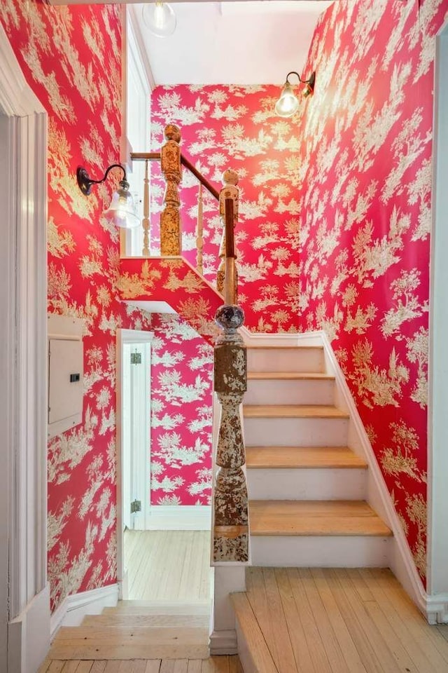 149 E 18th St Unit 2, New York City, NY 10003 - staircase featuring hardwood / wood-style flooring, wallpapered walls, and baseboards