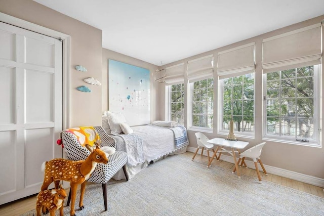 149 E 18th St Unit 2, New York City, NY 10003 - bedroom with multiple windows, baseboards, and wood finished floors