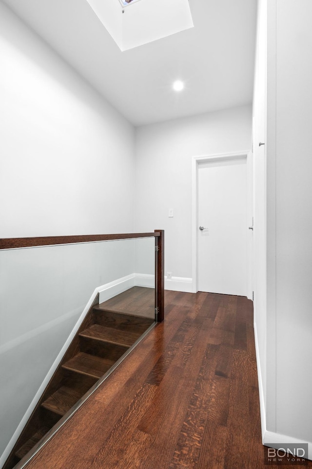 82-15 Penelope Ave, New York City, NY 11379 - hall featuring wood finished floors, stairs, a skylight, baseboards, and recessed lighting